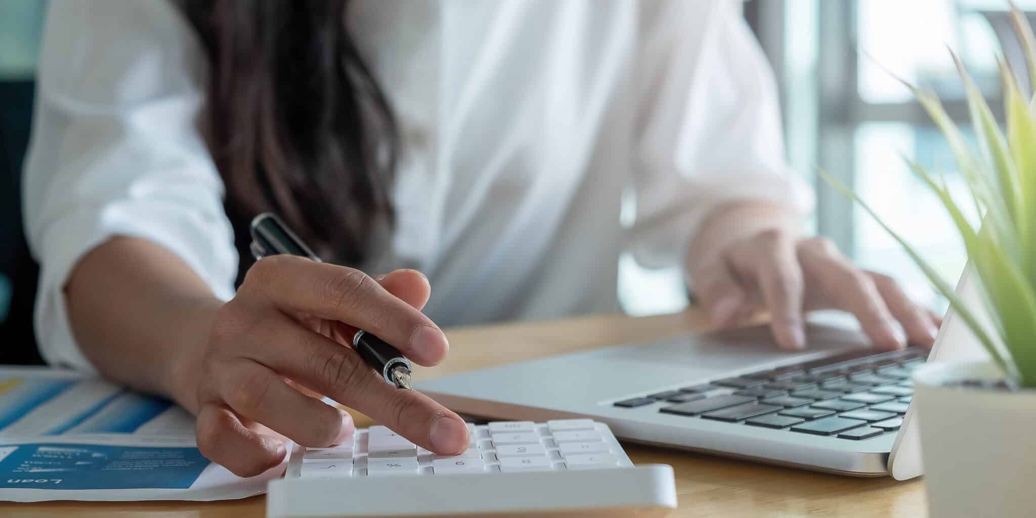 12102 Procurement And Purchasing Agents And Officers WorkPEI   Vecteezy Close Up Of A Woman Using A Calculator And Laptop 2295317 Scaled 